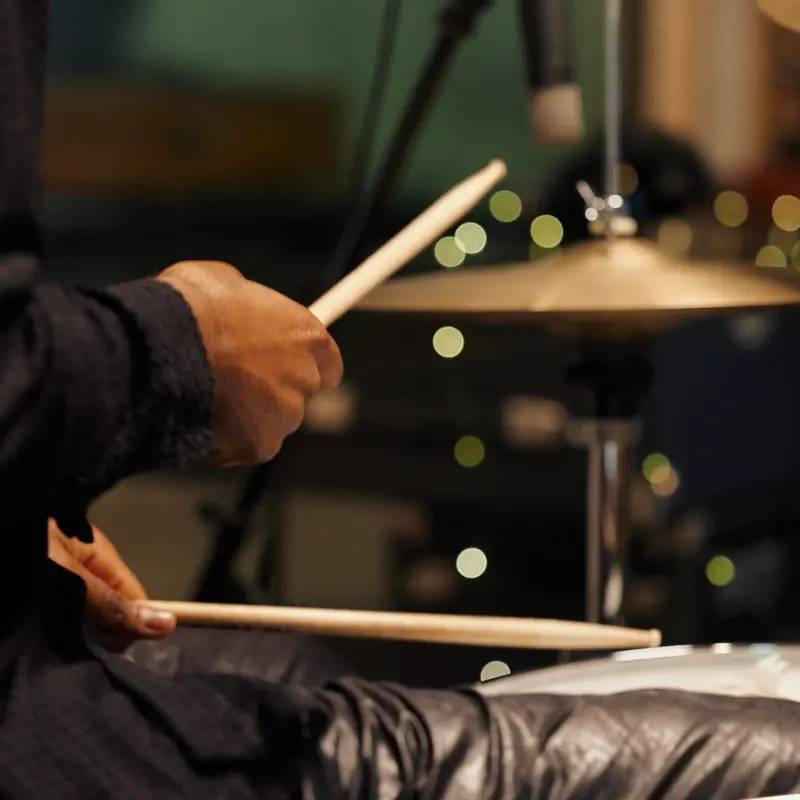 Man drumming with symbol